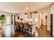 Open kitchen with a center island, pendant lighting, stainless appliances, hardwood floors, and backyard access at 230 Mackenzie Ct, Covington, GA 30016