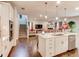 Stylish kitchen with island seating, open layout, stainless appliances, and view into a carpeted living room at 230 Mackenzie Ct, Covington, GA 30016