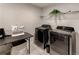 Modern laundry room featuring appliances, shelving, and folding table at 230 Mackenzie Ct, Covington, GA 30016