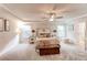 Spacious bedroom features tray ceilings, neutral decor, and plenty of natural light from the windows at 230 Mackenzie Ct, Covington, GA 30016