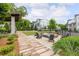 Community fire pit area with lounge chairs, lush landscaping, and views of the surrounding homes at 24 Becker Nw Pl, Atlanta, GA 30307