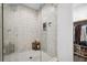 Contemporary shower with stylish tile, glass enclosure, and built-in shelving, next to closet at 24 Becker Nw Pl, Atlanta, GA 30307