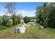 Aerial view of a charming home surrounded by lush greenery and a long, private driveway at 2552 Scenic S Hwy, Snellville, GA 30078