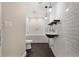 Modern bathroom with white subway tile, unique vanity, floating shelf, and dark herringbone floor at 2552 Scenic S Hwy, Snellville, GA 30078