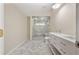 A modern bathroom featuring herringbone tile floors, double sink vanity, and a frameless glass shower at 2552 Scenic S Hwy, Snellville, GA 30078