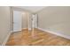 A bright bedroom with hardwood floors, neutral walls, and a closet with white doors at 2552 Scenic S Hwy, Snellville, GA 30078
