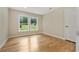 A cozy bedroom with hardwood floors, neutral walls, and double windows overlooking the property at 2552 Scenic S Hwy, Snellville, GA 30078