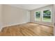 Bright bedroom with hardwood floors, two windows providing natural light, and neutral walls at 2552 Scenic S Hwy, Snellville, GA 30078