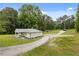 Charming exterior surrounded by lush greenery and a long driveway at 2552 Scenic S Hwy, Snellville, GA 30078