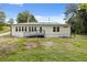 Rear exterior showcasing white siding, a ramp, and a lush green lawn at 2552 Scenic S Hwy, Snellville, GA 30078
