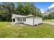 Charming exterior featuring light gray siding and a welcoming front porch nestled within a green lawn and mature trees at 2552 Scenic S Hwy, Snellville, GA 30078