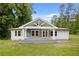 Charming home featuring a welcoming front porch, gray accents, and a well-manicured lawn at 2552 Scenic S Hwy, Snellville, GA 30078