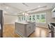 Spacious kitchen featuring an island with a sink, stainless steel appliances, and hardwood floors at 2552 Scenic S Hwy, Snellville, GA 30078