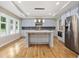 Modern kitchen with gray cabinets, stainless steel appliances, and a large island with marble countertop at 2552 Scenic S Hwy, Snellville, GA 30078