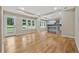 Open-concept living area with hardwood floors, large windows, and a view into the modern kitchen at 2552 Scenic S Hwy, Snellville, GA 30078