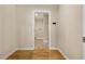 A neutral colored mudroom with hardwood floors, coat rack, and laundry room leading to a laundry room at 2552 Scenic S Hwy, Snellville, GA 30078
