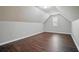 Spacious attic featuring wood floors, neutral paint, and a small window at 46 Highland Ct, Carrollton, GA 30116