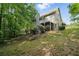 Backyard of home with deck and spiral staircase surrounded by mature trees at 46 Highland Ct, Carrollton, GA 30116