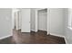 Bedroom featuring wood floors, closet, and neutral paint at 46 Highland Ct, Carrollton, GA 30116