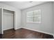 Bedroom featuring wood floors, a large window, and closet at 46 Highland Ct, Carrollton, GA 30116