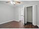 Bedroom featuring ceiling fan, wood floors, and closet at 46 Highland Ct, Carrollton, GA 30116