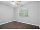 Bedroom featuring ceiling fan, wood floors, and window at 46 Highland Ct, Carrollton, GA 30116