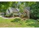 Traditional home exterior with brick and siding accents, surrounded by mature trees and landscaping at 46 Highland Ct, Carrollton, GA 30116