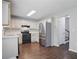 Charming kitchen featuring stainless steel appliances and hardwood flooring at 46 Highland Ct, Carrollton, GA 30116
