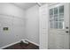 Bright laundry room featuring a wire shelf, white walls, and wood-look flooring for convenience and organization at 46 Highland Ct, Carrollton, GA 30116