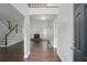 Open-concept living space featuring soaring ceilings, dark wood flooring, and staircase at 46 Highland Ct, Carrollton, GA 30116