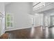 Bright living area with high ceilings, fireplace, and large windows, complemented by dark hardwood floors at 46 Highland Ct, Carrollton, GA 30116