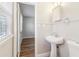 Bathroom with beadboard walls, pedestal sink, and access to a bedroom at 6071 Cristie Dr, Ellenwood, GA 30294