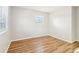 Sunlit bedroom featuring wood-look floors and a double window allowing natural light at 6071 Cristie Dr, Ellenwood, GA 30294
