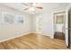 Bedroom featuring modern ceiling fan, laminate floors and a view to the hallway and bathroom at 6071 Cristie Dr, Ellenwood, GA 30294