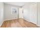 Bedroom with wood-look floors, neutral paint, and a window for natural light at 6071 Cristie Dr, Ellenwood, GA 30294