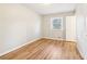 Bright bedroom featuring wood-look floors and a window allowing natural light at 6071 Cristie Dr, Ellenwood, GA 30294