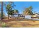 Charming home with brick and siding, set on a well-maintained lawn with mature trees under a beautiful blue sky at 6071 Cristie Dr, Ellenwood, GA 30294