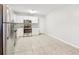 Bright kitchen featuring stainless steel appliances, white cabinets, and tile flooring at 6071 Cristie Dr, Ellenwood, GA 30294