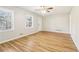 Inviting living room with hardwood floors, a ceiling fan, and bright windows at 6071 Cristie Dr, Ellenwood, GA 30294