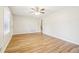Bright living room features wood flooring, neutral walls, ceiling fan and window at 6071 Cristie Dr, Ellenwood, GA 30294