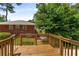 Backyard view from wooden deck, showcasing ample green space and mature trees at 1364 Willis Mill Sw Rd, Atlanta, GA 30311