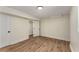 Finished basement area with wood flooring, white trim, and interior access door at 1364 Willis Mill Sw Rd, Atlanta, GA 30311