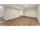 Finished basement area with wood flooring, stairs, and a back door at 1364 Willis Mill Sw Rd, Atlanta, GA 30311