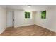 Finished basement featuring wood floors, natural lighting, and an exterior door at 1364 Willis Mill Sw Rd, Atlanta, GA 30311