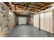 Unfinished basement featuring stone foundation walls, concrete floor, and access to garage at 1364 Willis Mill Sw Rd, Atlanta, GA 30311