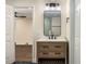 Bathroom featuring black hexagon floors, wood vanity with a white counter, and a modern mirror at 1364 Willis Mill Sw Rd, Atlanta, GA 30311