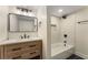 Modern bathroom with black hardware, subway tile shower, and wood vanity at 1364 Willis Mill Sw Rd, Atlanta, GA 30311