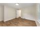 Bright bedroom with wood floors, white trim, and two doors at 1364 Willis Mill Sw Rd, Atlanta, GA 30311