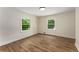 Bright bedroom with wood floors and two windows providing ample natural light at 1364 Willis Mill Sw Rd, Atlanta, GA 30311
