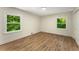 Bedroom featuring wood floors, neutral walls, white trim, and two windows at 1364 Willis Mill Sw Rd, Atlanta, GA 30311